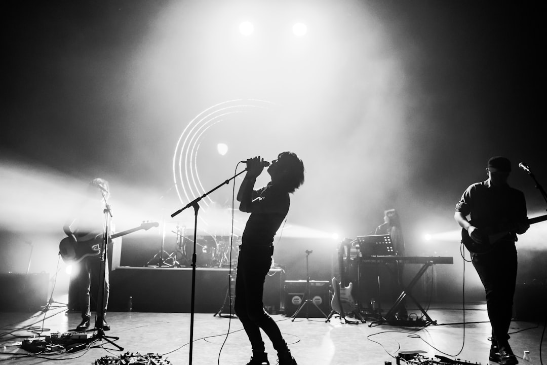 man singing on stage in front of people